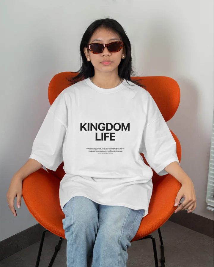Kingdom Life t-shirt worn by a woman on an orange chair